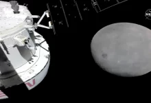 Photo of NASA capsule buzzes moon, last big step before lunar orbit